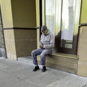 dejected man with phone sitting on steps
