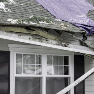 house with badly damaged roof