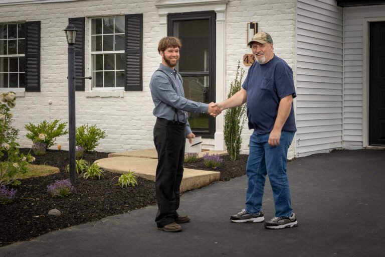 Mel shakes hands with a happy client